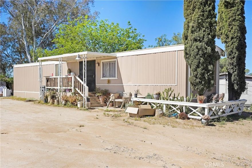 This 2-bedroom, 2-bath manufactured home on a Permanent foundation boasts nearly a HALF ACRE lot, giving you the kind of breathing room that’s hard to find. Past the private gate, the home is set back from the road, surrounded by open space and a sense of quiet that makes it feel like your own tucked-away retreat. Inside, you’ll find laminate flooring throughout and an updated kitchen that keeps things light and practical. The expansive lot opens the door to all kinds of possibilities—space for projects, storage, parking, or even future plans you’ve been waiting to bring to life. With no immediate neighbors crowding in, it’s a spot for anyone who values privacy and wide-open potential. Broker and agents do not represent or guarantee the accuracy of the square footage, income, expenses, condition, development potential, bedroom/ bathroom count, lot size or lot lines, dimensions, permitted or non-permitted spaces, or school eligibility. Buyer is advised to independently verify the accuracy of all information with appropriate professionals. There are no warranties or guarantees, buyer to rely solely on his/her/their own findings.
