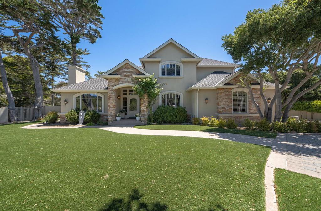 Privately tucked behind a gated entrance and enclosed by a gracefully curved stucco wall, 471 El Dorado is one of Monterey's most quietly distinguished homes. Nearly 2,900 sq ft of light-filled space features soaring ceilings, rich wood finishes, and three fireplaces throughout formal and casual living areas. The well-appointed kitchen opens to a private stone patio, ideal for outdoor dining or relaxing in the coastal air. Upstairs, the primary suite offers vaulted ceilings, a fireplace, walk-in closet, and a spa-like bath with soaking tub and separate shower. With three bedrooms plus a versatile bonus room ideal as an office, den, or guest space the layout offers flexibility for a variety of lifestyles. A spacious 3-car garage provides ample storage. The entire property, set on over 11,000 sqft, feels peaceful and private, yet close to everything. Just minutes from the Monterey Bay shoreline, Cannery Row, Pebble Beach, Carmel-by-the-Sea, and the Monterey Airport. Enjoy walkability to the Bay, coastal trails, dining, and recreation. A rare coastal retreat offering comfort, elegance, and timeless design in one of the Peninsula's most sought-after enclaves.