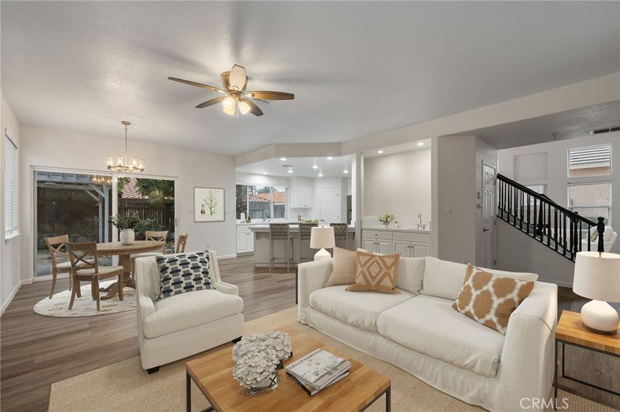 Beautifully updated 4-bedroom, 3-bath home featuring soaring ceilings, wood-look flooring, and a flowing open layout ideal for everyday living and entertaining. The formal living room offers a cozy fireplace, while the spacious family room includes a second fireplace and a stylish wet bar with easy kitchen access. The bright kitchen features white cabinetry, quartz countertops, and a large breakfast bar. A convenient downstairs bedroom with nearby bath is perfect for guests or multigenerational living. Upstairs, the spacious primary suite boasts a dual-sided fireplace shared with a spa-like bathroom featuring a soaking tub, separate shower, and dual sinks. The private backyard includes a built-in BBQ grill, pergola-style covered patio with ceiling fan, and mature trees for added privacy. A 3-car garage completes this move-in-ready home located in the desirable Stockdale High School district, close to shopping, dining, and everyday conveniences.