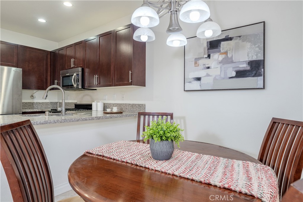 Step into this beautifully designed 3-bedroom home plus a DEN and 3.5 bathrooms, which showcases the largest floor plan in the community at an impressive 1,725 square feet. The first level welcomes you with a versatile den, perfect for a home office or cozy reading nook, along with a thoughtfully positioned half bathroom. Ascending to the second level, you will love the sleek, contemporary kitchen that boasts stainless steel appliances, elegant granite countertops, and a practical serve-over bar that offers casual dining and lively entertaining. Adjacent to the kitchen, an inviting eat-in area provides the perfect space for morning coffee or family meals. The living room serves as the heart of this home, effortlessly connecting to a tranquil outdoor patio—a private sanctuary ideal for relaxation after a long day or for hosting delightful summer barbecues with friends and family. On this level, you'll also find another well-appointed bedroom and a stylish walk-in shower, enhancing the home's comfort and convenience. The third level reveals a dedicated laundry room, two full bathrooms, and a secondary bedroom, alongside the primary suite. This secluded retreat features an en suite bathroom and a spacious walk-in closet, providing both luxury and practicality. Completing this remarkable property is a spacious 2-car side-by-side garage, ensuring ample parking for you and your guests. Nestled within the charming Lotus Walk Community, residents are treated to a lifestyle enriched by desirable amenities, including water utilities, a sparkling community pool, a soothing spa for unwinding, and a welcoming BBQ area ideal for gatherings with friends and neighbors. Conveniently located just a short stroll from the picturesque Haster Basin Recreational Park and the exhilarating Great Wolf Lodge Water Park, this home is a true entertainer's paradise, with the magic of Disneyland only 2 miles away. Easy access to major freeways, including the I-5 and I-22, enhances daily commuting for ultimate convenience. With a vibrant array of restaurants and shops lining Main Street, everything you need is right at your doorstep. Indulge in the perfect blend of comfort, style, and convenience in this remarkable home. HOA includes water, garbage, sewer, outside landscaping, and the common area.