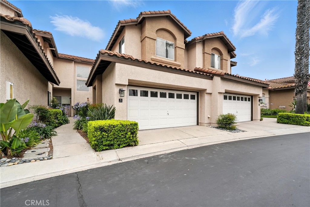 Welcome to 5 Pappagallo Ct, Aliso Viejo! A stunningly remodeled townhome nestled in the prestigious Windwards community. This light filled residence boasts soaring 30+ foot cathedral ceilings in the living room, creating an airy and dramatic first impression. Thoughtfully updated throughout, the home features designer vinyl plank flooring, recessed lighting, and a freshly painted interior and garage. The chef inspired kitchen is a showstopper, complete with quartz countertops, custom shaker cabinetry, a stainless steel utility sink and faucet, stylish backsplash, and pendant lighting over a spacious island, perfect for entertaining. Remodeled bathrooms showcase modern vanities and finishes, adding a touch of luxury to everyday living. Step outside to a lush, manicured backyard adorned with vibrant rose bushes, bougainvillea, and a fruiting lemon tree your own private oasis. Located in a highly desirable neighborhood with a wonderful community Pool and Spa. Just minutes from Laguna Beach, major freeways, restaurants, and shopping centers, this home offers the perfect blend of tranquility and convenience Don’t miss the opportunity to own this turnkey gem in one of Aliso Viejo’s most sought after communities!