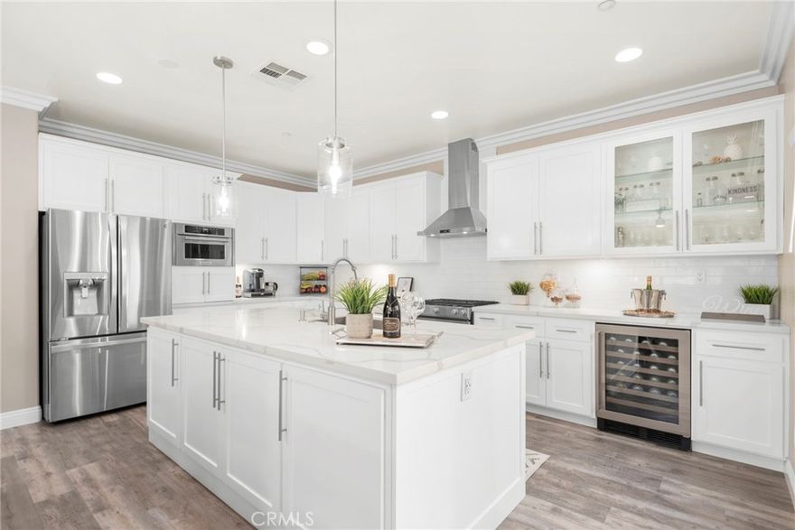 Welcome to Your Dream Condo in the Highly Sought-After Brighton at Etiwanda Community- BUILDING #3! This stunning residence boasts the second-largest floor plan in the community and showcases an open-concept layout that perfectly blends space, style, and comfort for modern living.
Downstairs, you’ll find a beautifully upgraded kitchen with quartz countertops, a large island accented with pendant lighting, stainless steel appliances, a wall-mounted range hood, wine fridge, built-in microwave, an a backless gas range with oven, pantry, crown molding, central air and heating, and laminate flooring flow seamlessly into the spacious family room, complete with a cozy electric fireplace, ceiling fan, and sliding glass doors leading to a sunny tiled patio with a charming Pergola, perfect for relaxing or entertaining in style. Adjacent to the kitchen is a dedicated dining area, ideal for family meals and gatherings. The attached two-car garage with direct access features epoxy flooring and a large mirrored storage closet-ideal for storing seasonal décor and more. A convenient half-bathroom and additional storage closet complete the lower level.
Upstairs, enjoy a laundry area behind elegant double frosted glass doors, with built-in cabinetry for added storage. The spacious primary suite boasts a charming chandelier, walk-in closet with built-in organizers, mirrored doors on both sides, and a chandelier. The en-suite bathroom offers a dual-sink vanity, a soaking tub, and a glass-enclosed shower with dual access (one leading to the soaking tub). Two additional bedrooms each feature ceiling fans and mirrored closet doors, offering comfort and functionality, they share a well-appointed full bathroom with double sinks, and a hallway storage closet offers even more convenience. The HOA dues cover water, insurance, and front yard maintenance, providing a low-maintenance lifestyle. Community amenities are plentiful, including a sparkling pool and spa, outdoor showers, BBQ and picnic areas, and playgrounds-perfect for leisure and fun.Prime location with quick access to the 15 and 210 freeways, and just minutes from Victoria Gardens Shopping Mall. This move-in-ready home perfectly blends luxury, function, and style-all within a well-maintained and desirable community.  Don’t miss the opportunity to make it yours!
Schedule a private tour today and experience the lifestyle you deserve!