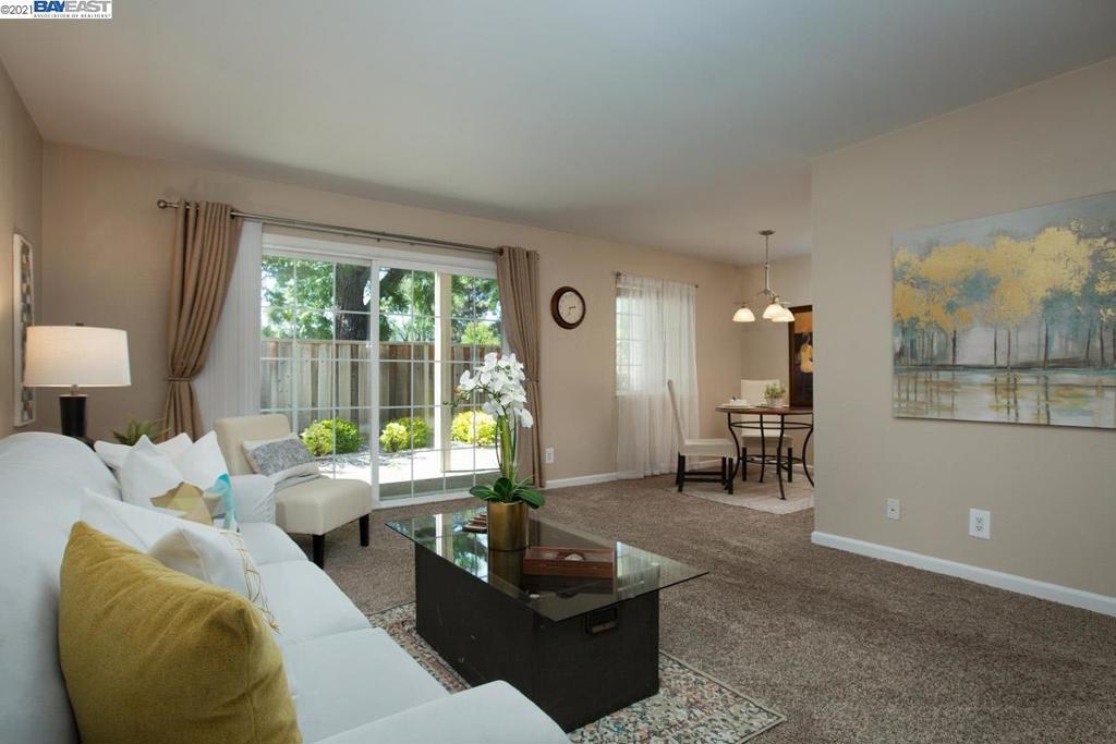 Vacant, updated and ready-to go! Modern bath and kitchen, stainless steel appliances, granite counters, engineered hardwood and designer paint. Model home look and feel that's move-in ready. No steps to entry. Private and fenced-in patio. Community pool, barbecue area and laundry just steps away. Carport parking space is a short distance from the front door; communal single parking space in front of home. Downtown Pleasanton and fairgrounds are just down the street. This one will not last!