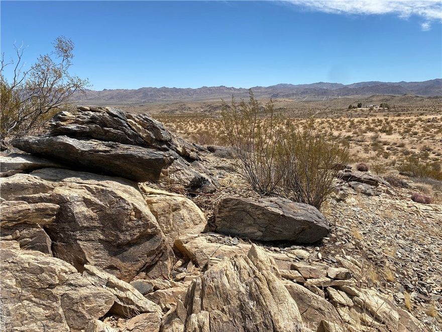 Large 5 Acre Parcel With Scenic Views and Natural Boulders! We invite you to be captivated by this one-of-a-kind 5-acre landscape in Joshua Tree, featuring its own legal address at 3025 Flamingo Ave., which helps streamline the development process. One of the main reasons people flock to our beautiful desert is its unique and breathtaking scenery. 



As you drive to this majestic property, you’ll feel a sense of relief, surrounded by vast panoramic views and bright blue skies. This parcel not only boasts one of the most epic backdrops the high desert has to offer, but it also features beautiful natural boulder rock formations, making it a true Joshua Tree masterpiece. 



Located just minutes from the charming Joshua Tree village—filled with boutique shopping and gourmet dining—and a short drive from the breathtaking Joshua Tree National Park, this location provides the solitude you seek while keeping you close to the area's major attractions. 



Walking the property is not just a viewing experience; it's an immersion in the landscape. Whether you’re looking to build a second home, an investment property, or a primary residence, this is a truly unique opportunity to own your own stunning piece of the desert. This property is the one you’ve been waiting for! Call today to arrange a showing before it’s gone!