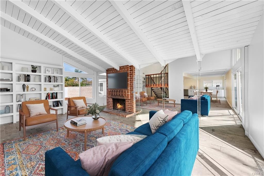 This great airy and light open-concept home is close to everything you desire. Nestle within the sought-after Chancellor neighborhood, the two-story residence is moments from excellent Irvine schools, shopping centers, a broad selection of restaurants, hiking trails and parks. The extensively customized design presents four bedrooms and two baths in approximately 2,093 square feet. Two bedroom are located on the first floor, and a third bedroom is located upstairs next to the primary suite, where a walk-in shower, custom two-sink vanity, bay window and vaulted ceiling are showcased. Enjoy the intrinsic style of open-beam ceilings, wood-look plank flooring, a floating staircase, and large upgraded windows and sliding-glass doors that bathe the home in natural light. Double entry doors open to the main level, where a formal living room with brick fireplace is perfect for entertaining, and a dine-in kitchen with adjacent family room hosts upgraded quartz countertops, a garden window, white cabinetry, stainless-steel appliances a farmhouse sink. An interior laundry room and an attached two-car garage with direct interior access are featured. Lot 5,000 square feet, grounds are low maintenance and display a private, gated front patio and a backyard for fun times with friends and neighbors. This house is convenient to William R. Mason Regional Park, trails at the scenic San Joaquin Marsh, tennis courts, and for kids, the Adventure Playground at University Park. Elementary school, middle school, UNI-highschool, UCI nearby, and Irvine Spectrum, Newport Beach and the Orange County Airport are close to home.