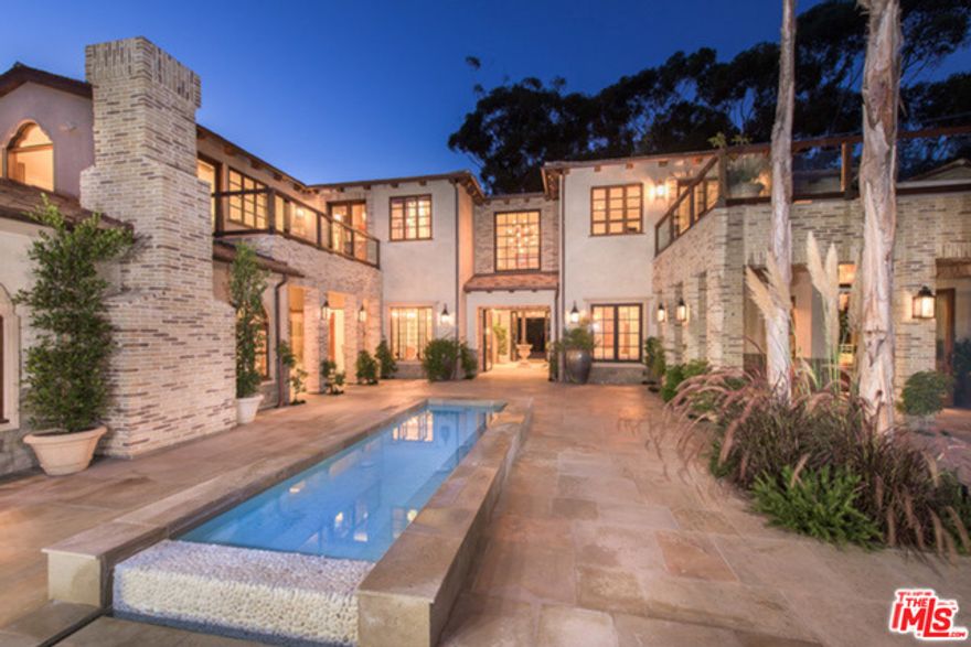 Tucked away on a private road of intimacy and prestige, this brand new construction of tranquility, quality, and Paladian style design, will take your breath away. Enter through an antique Portuguese front door to find 8 bedrooms, 12 baths, home theater, game room, gym, wine tasting room housing 3,000 bottles and dual master baths which spoil you with Japanese soaking tub, traditional dressing rooms with contemporary finishes and 50 linear feet of closet space, walnut library, imported custom lighting throughout, teppanyaki grill and pizza oven. Spectacular gourmet chefs kitchen designed with exclusive portabella cabinets seamlessly opens to the resort style grounds which surround an oversized guest house, pool cabana with dry and steam sauna and a magnificent 360 zero-edge pool. To help set the stage are olive trees planted in 1906.