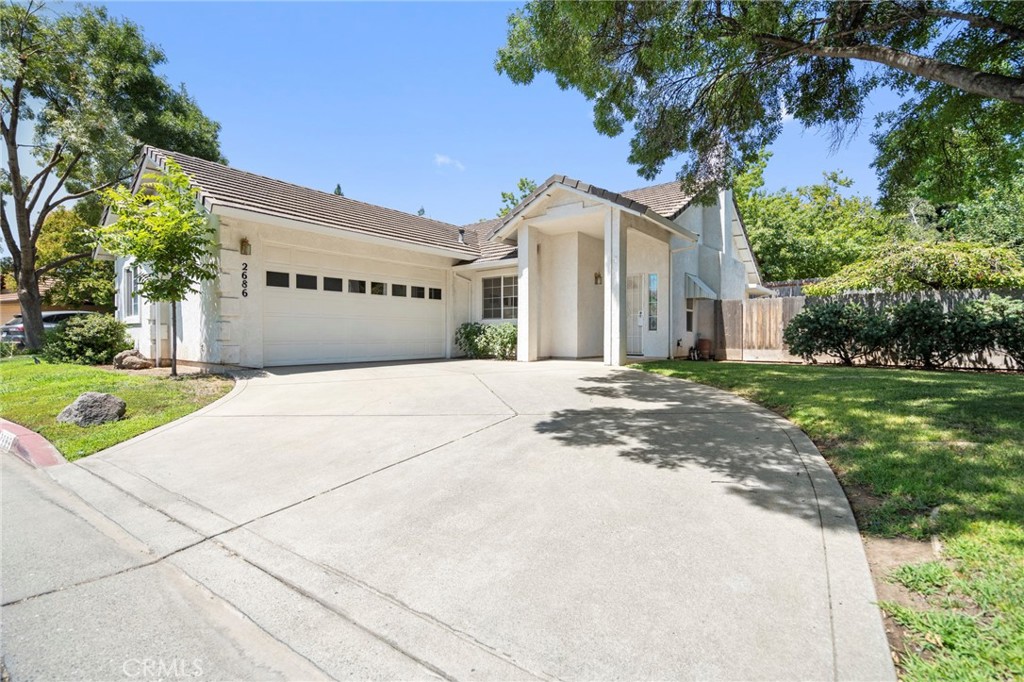 Welcome to 2686 Fairfield Common, a charming retreat tucked within the highly desirable Sierra Sunrise 55+ COMMUNITY in California Park, where low-maintenance living meets a beautifully natural setting. Just moments from the tranquil lake, walking trails, and private park access, this home offers the perfect blend of independence, serenity, and connection. Step inside and you'll immediately notice the natural light that floods the living space, thanks to the vaulted ceilings and large windows that bring the outdoors in. The living room features a cozy gas fireplace that anchors the space, creating a warm spot to relax or entertain. Just off the living room, the dining area and kitchen offer a functional layout with ample cabinet space, ideal for whipping up a quick lunch before your afternoon stroll by the lake or hosting friends for dinner. Down the hallway, you'll find all three bedrooms thoughtfully arranged for both privacy and convenience. The generously sized primary suite is a true retreat with direct access to the backyard patio, a walk-in closet, and a bright en-suite bathroom complete with dual sinks and a walk-in shower. The two guest bedrooms are perfect for visiting family or hobbies, and the guest bathroom sits conveniently nearby. The indoor laundry room leads directly to the attached 2-car garage, offering plenty of storage and easy access. Outside, the backyard is private and low-maintenance with a spacious concrete patio, just right for sipping your morning coffee, reading a good book, or enjoying a peaceful evening under the stars. Surrounded by mature trees and nestled within one of Chico's most scenic neighborhoods, this home offers the opportunity to live independently, comfortably, and fully. Enjoy all the perks of the California Park lifestyle: serene lake views, miles of trails, nearby medical facilities, and a close-knit community designed for those who value both simplicity and beauty in their everyday living. At 2686 Fairfield Commons, your next chapter starts here!