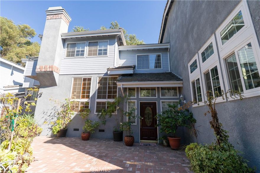 Tucked away in a serene, gated enclave of just six units, this unique and spacious tri-level townhome offers a rare blend of privacy, comfort, and convenience in a coveted Calabasas-adjacent location. Nestled next to a peaceful natural ravine and surrounded by rolling lawns and mature trees, this home feels like a tranquil mountain retreat while being just minutes from The Commons, shopping, dining, and top-rated schools. Enjoy a private entrance and direct access from the attached two-car garage. Inside, the large living room features a fireplace and opens to a separate formal dining area, perfect for entertaining. The kitchen is complete with a center island, breakfast nook, and a pass-through bar to the cozy den, which includes a ceiling fan and balcony access. Upstairs, you’ll find two spacious en-suite bedrooms with high ceilings and walk-in closets. The expansive primary suite includes vaulted, beamed ceilings and a luxurious bathroom with dual sinks, a spa tub, and a separate stall shower. Convenient upstairs laundry is located near the bedrooms for added ease. Light pours in through multiple balconies, and the thoughtful design includes few shared walls, offering exceptional privacy and natural light throughout. Mulholland Meadows boasts stunning curb appeal with lush greenbelt areas and soaring trees, giving the community a resort-like ambiance. If you’re seeking a peaceful setting close to the heart of the city, this townhome is not to be missed.