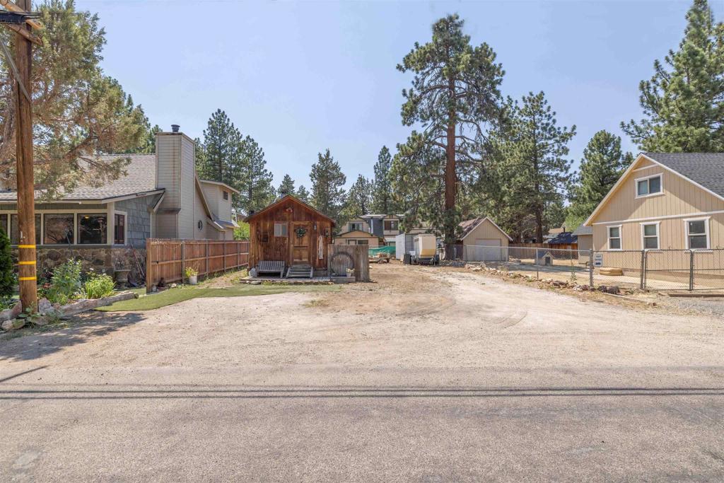 Discover the perfect canvas for your mountain dreams with this rare flat and fully usable lot in the heart of Sugarloaf. Tucked in a peaceful, tree-lined neighborhood, this property offers the ideal setting to build your custom cabin or retreat. What truly sets this opportunity apart? A charming, historic cabin structure—not affixed to the land—is included and will convey with the property. With some creativity, it could serve as the foundation for a future tiny home, studio, or guest space. Whether you're looking to build now or hold as an investment, this lot offers endless potential in one of Big Bear’s most beloved communities. Home located next-door is hooked up to sewer, city, water, gas, electric, and phone service.