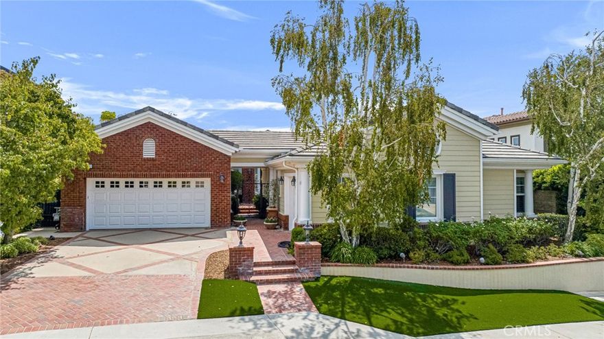 In the prestigious 24-hour guard-gated Renaissance community of Porter Ranch, this exquisite 4-bed, 3 ½-bath home offers 3,194 sqft of refined living space, blending timeless elegance with modern convenience. Rare 1-story! Amazing views of mountains and valley lights! The front walkway leads into a wonderfully private front courtyard. Impressive brick archway frames the entry and the stunning foyer creates an unforgettable first impression. Luxurious touches throughout, include high ceilings, recessed lighting, plantation shutters, limestone floors, and more! The open floorplan, formal living and dining areas offer decorative tray ceilings, a rounded bay window, and French doors, maximizing the wonderful view. A butler’s pantry links seamlessly into the gourmet kitchen, designed for both entertaining and everyday indulgence, complete with granite counters, central island with prep sink, high-end, stainless-steel appliances, and sunlit breakfast nook with sliding glass doors out to the patio. Adjoining family room boasts a granite-surround fireplace, built-ins, tray ceiling, and French doors to the front courtyard. The primary suite provides a serene retreat with decorative tray ceiling, crown molding, space for a sitting area, and French doors. The lavish en-suite bath includes dual vanities, jetted soaking tub, walk-in shower, and walk-in closets. A generous secondary suite has private French doors out to the courtyard and a beautifully appointed, en-suite, ¾ bath. Two additional, sizable, bedrooms share a full Jack-and-Jill bath with dual sink vanity. Additional features include a dedicated laundry room with utility sink and icemaker, attached 2-car garage and a separate attached 1-car garage, both with direct access. Outdoors, the yard is designed to maximize enjoyment of the breathtaking panoramic views. A covered brick patio with ceiling fan, heaters, built-in speakers, and built-in BBQ is designed for year-round entertaining and complemented by a spa with waterfall feature, drought conscious turf lawn and landscaping, and additional patio areas for seating and soaking it in. Well situated near local parks, nature trails, shopping, dining, and entertainment, including the Vineyards, and the 118 Freeway. Combining timeless design with modern comforts, this home presents a rare opportunity to enjoy luxury living in one of the Valley’s most coveted communities. Don’t miss your chance!