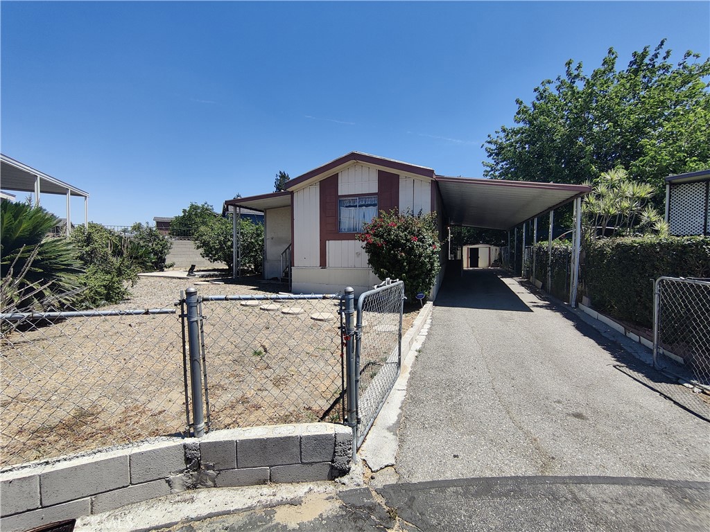 This single wide manufactured home is located on a prime lot in the Rialto Mobile Villa park. It is on a large corner lot with several fruit trees and plenty of space. The home is a 2 bedroom, 1 bathroom home with an open living room and kitchen area. There is an additional room that could be used as an office or 3rd bedroom.