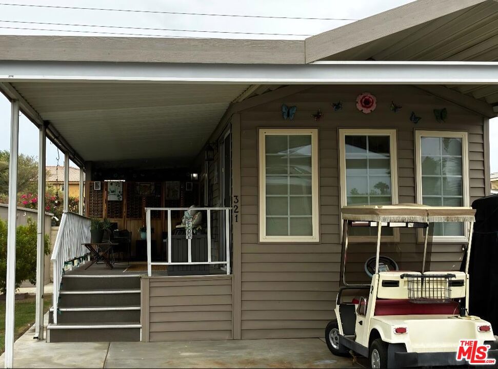 This is well kept with upgraded flooring and open living space. The patio is partial enclosed off the back, creating a wind break and some outdoor privacy. It is located on the wall with a small back walkway with your shed at the foot of the stairs. The patio is set up for afternoon entertaining. It includes golf cart for scooting around the community. This all located in a 55+ community that has a 3 par golf course, chipping green, putting green, 9 hole mini golf, pickleball and tennis courts, bocce ball, an indoor shuffleboard courts, 2 clubhouses with pools and jacuzzies and an additional 4 satellites with pool, jacuzzies and mail boxes. This is all within a 24 hour gate guarded community of 801 lots, that consist of a combination of Park Models and RV lots, where you own the land. The resort has a limit of 270 day occupancy. It is a perfect place to spend your holidays in the sunshine.
