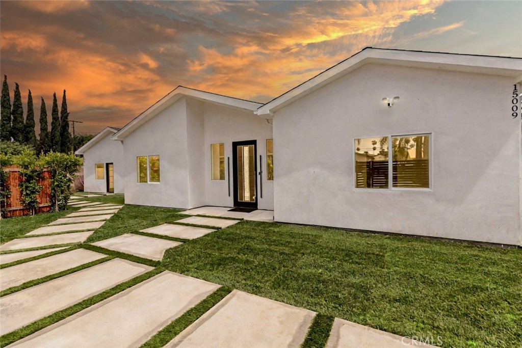 Introducing a rare brand-new construction opportunity in the heart of Van Nuys, offering a total of 6 bedrooms and 5.5 bathrooms across a spacious 3,100 square feet. This exceptional property includes a beautifully designed main residence and a fully permitted ADU—ideal for multi-generational living or generating additional rental income.
The main home features 4 bedrooms and 3 full bathrooms, including two ensuite bedrooms for ultimate privacy and comfort, plus two additional bedrooms and a hallway bath. The open-concept layout is highlighted by wide-plank engineered flooring, soaring ceilings, and sleek finishes throughout. A chef’s dream kitchen boasts custom cabinetry, quartz countertops, and modern appliances, seamlessly connected to expansive living and dining areas.
The attached ADU offers 2 ensuite bedrooms and a separate half bath, complete with its own entrance, designer kitchen, and contemporary styling—perfect for extended family, guests, or tenants.
Energy-efficient features include solar panels, dual-pane windows, and tankless water heaters. The property is finished with fresh landscaping, private yard space, and paved walkways, creating a wonderful retreat.