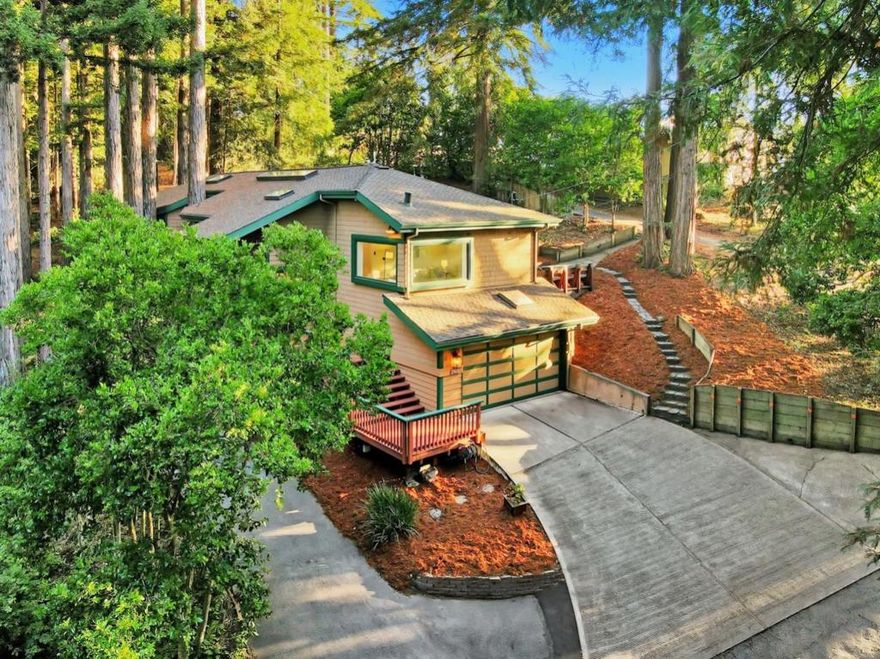 Tucked away in a quiet valley and embraced by towering redwoods, this inviting mountain home is the ideal getaway for those craving serenity and a close connection to nature. Designed to harmonize with its surroundings, the home features soaring ceilings, expansive windows, and sliding glass doors that flood the space with natural light and forest views. Perfect for indoor-outdoor living and entertaining, the open-concept layout flows easily onto a private patio, ideal for grilling, relaxing, or gathering with friends. In the heart of the home, the kitchen and dining area are warm and welcoming, with plenty of space for hosting. The bedrooms are generously sized, with the primary suite offering a luxurious ensuite, built-in closet, and a private deck tucked into the trees. Above the bedrooms, cozy loft-style nooks provide the perfect hideaway for reading, play, or quiet retreat. A flexible fourth bedroom is currently outfitted as a home gym, ideal for fitness, a hobby room, or a home office. A spacious workshop with plenty storage space, and the attached two-car garage adds even more functionality. Whether you're seeking a full-time residence or a peaceful weekend escape, this redwood valley retreat offers the perfect blend of comfort, natural beauty, and laid-back living.
