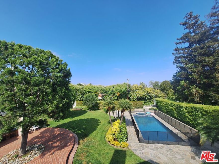 Nestled in the prestigious Beverly Hills Flats set on half an acre offers a fully gated residence boast for privacy and security, 4 bed and 4.5 bath with  an attached two-story guesthouse The oversized primary bedroom is accentuated by an elegant fireplace, steam shower, and his & her closets and sitting area, balcony overlooking backyard. Two living rooms, dinning room, breakfast room and Family room opens to patios, lawns, pool. Moments away from the best Los Angeles has to offer including the famed Rodeo Dr, Beverly Hills Hotel and countless exquisite dining options.