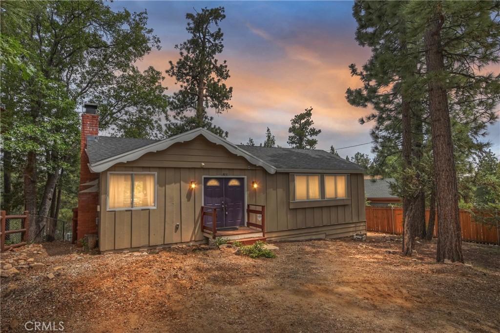 Located in desirable Moonridge, this clean and cozy single story Sierra-style cabin is a great escape from the city. Inside, you’ll find vaulted knotty pine ceilings and a traditional brick fireplace that add warmth and character to the living space. The open layout seamlessly flows to the kitchen where a sliding door leads you to an expansive back deck where you can enjoy the fresh mountain air, savor your morning coffee, or unwind after a day of outdoor adventure while enjoying the treed views. Set on a large corner lot, the property allows for ample parking with potential to add a garage or expand future amenities. Located just minutes from Bear Mountain Ski Resort, the Alpine Zoo, Moonridge Coffee and other great attractions. Come view this mountain escape which will allow you to slow down, breathe deep, and savor the beauty of Big Bear living.