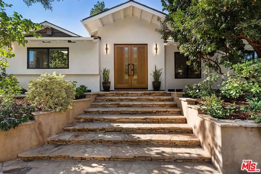 Nestled off the street in a highly desirable neighborhood south of Ventura, this custom-built, single-story classic sits on close to half a wooded acre, offering a uniquely tranquil and private estate that perfectly matches modern conveniences with the charm of a traditional California-style home. The beautifully landscaped grounds provide a lush outdoor oasis with a grassy lawn, a large brick patio, and a pool with a waterfall, ideal for entertaining or relaxing; French doors in the primary suite, living room, and family room create seamless indoor-outdoor living. Inside, the four-bedroom, four-bathroom layout is both spacious and functional, featuring new hardwood floors throughout the main living areas, a new A.C. unit (2023), and a family room accentuated by a beamed ceiling and a stone fireplace. The newly updated gourmet kitchen boasts high-end appliances, quartz counters, and a seating area, while the serene primary suite is a true retreat with an oversized shower and a luxurious spa tub.