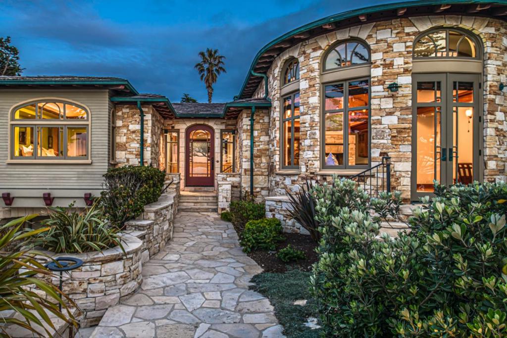 Offering an incredible combination of style, quality, and views, this Eric Miller designed residence was built in 2000 and is approximately 3,389 square feet on an oversized 6,000 sq. ft. lot on Carmel Point. The home consists of four bedrooms, three full baths, large open rooms, a master bedroom on the main level with sitting room/den, three spacious guest bedrooms, an office area, custom touches throughout with high ceilings, and an abundance of light. A stone exterior and private rear patio with an outdoor fireplace create an ideal setting to gather with friends, and the fire pit on the front patio is designed to maximize views down Carmel Beach to the Pebble Beach Golf Links- all just a few steps to the white sand.