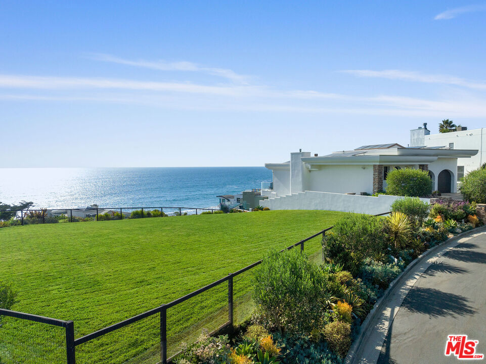 Set within the exclusive gates of Victoria Point in Malibu's sought-after Broad Beach area, this rare ocean-view land parcel comprised of two legal lots presents a unique opportunity to own a slice of California coastline. Elevated above the Pacific with sweeping views of the ocean, coastline, and Catalina Island, this fully landscaped lot offers privacy, prestige, and the potential for future useall within a community known for architectural excellence and natural beauty.Positioned behind secure gates, the parcel features a wide expanse of flat, usable land, framed by lush greenery and coastal plantings. For years, it has served as an extension of the neighboring residence, hosting private events, gatherings, and quiet moments overlooking the sea. The neighboring residence is currently listed for sale at $8,450,000 and can be purchased in conjunction with the adjacent land parcels if so desired. Whether envisioned as a serene outdoor space, ocean-view garden, dog run, or future asset, the parcel offers versatility and long-term value in a coveted location.Buyer to independently investigate the feasibility of any future development, construction, or improvements with the City of Malibu, Coastal Commission, and all appropriate governmental agencies. Seller and agents make no guarantees as to what may be developed. Buyer to satisfy themselves fully with all aspects of the property. Listing is two adjacent vacant lots: APN 4470-017-046 and APN 4470-017-047.