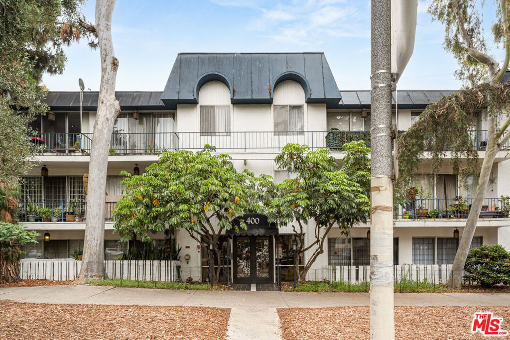 Tucked away on the quiet, elevated rear side of the building, this rare first-floor unit offers the privacy and feel of a second-floor home. No neighbors below and an oversized east-facing patio make this 1-bedroom, 2-bathroom residence truly special enjoy your morning coffee in a sun-drenched space that feels like your own secret garden. Inside, the generous 855 sq ft layout includes a spacious primary suite with en-suite bath, plus a separate hallway bathroom perfect for guests. The open-concept kitchen features granite countertops, ample cabinetry, and a charming breakfast nook that can double as a home office or reading corner. With just a touch of updating to suit your taste, this well-located and oversized unit is a prime opportunity in a highly sought-after area near Korea-town and DTLA. Don't miss the potential!