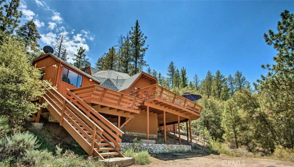 Discover mountain living at its best in this charming two-story cabin-style home. Offering 1,867 sq. ft. of living space, this residence features 3 bedrooms and 2 bathrooms, thoughtfully spread across two levels for comfort and functionality. Nestled on a spacious 14,810 sq. ft. lot, the home provides plenty of outdoor space to enjoy the fresh mountain air and natural surroundings. The cabin feel brings warmth and character, making it perfect as a full-time residence or a weekend retreat. With ample parking available in front, this property is ready to welcome family and friends for memorable gatherings. Don't miss the chance to own a peaceful mountain escape with room to relax and unwind.