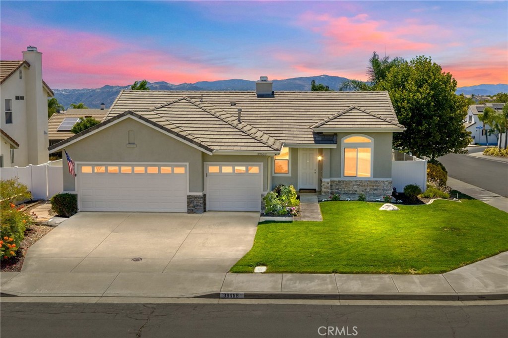 Positioned proudly on a corner lot in Murrieta with low taxes and no HOA, 39669 Candy Apple Way is the ideal property with timeless style. White and woodgrain, this home lives large and is the perfect mix of natural and warm. The moment you step inside you will be captivated by the extensive upgrades. Beautiful wood laminate flooring that runs throughout the main living and traffic areas, high ceilings and natural light fill the living, dining, kitchen and family room. Inviting kitchen with white cabinets, abundant pantry storage, countertop space, newer black stainless appliances, eating area open to family room with brick fireplace. Laundry room with built in cabinetry is so cute you will look forward to doing laundry! Bedrooms are generously sized with plenty of closet space and each with a ceiling fan. Primary bedroom includes walk-in closet, remodeled bath with designer fixtures and huge shower. Hall bathroom is tastefully updated as well. This three bedroom, two bath home offers more than space-it offers intension and functionality. Oversized 3 car garage with abundant attic storage means no gear gets left behind. Outside, a spacious solid covered patio welcomes gatherings, gardening dreams and producing fruit trees.(grapefruit, orange, plum and apricot.) Updates include: newer energy efficient Milgard windows throughout, flooring, carpet, baseboards, designer paint, kitchen appliances, quartz countertop, hot water heater, AC/HVAC, whole house fan, and vinyl fencing. Convenient access to freeways, shopping, parks, and schools is a bonus! This home is gracefully styled and will not last.
