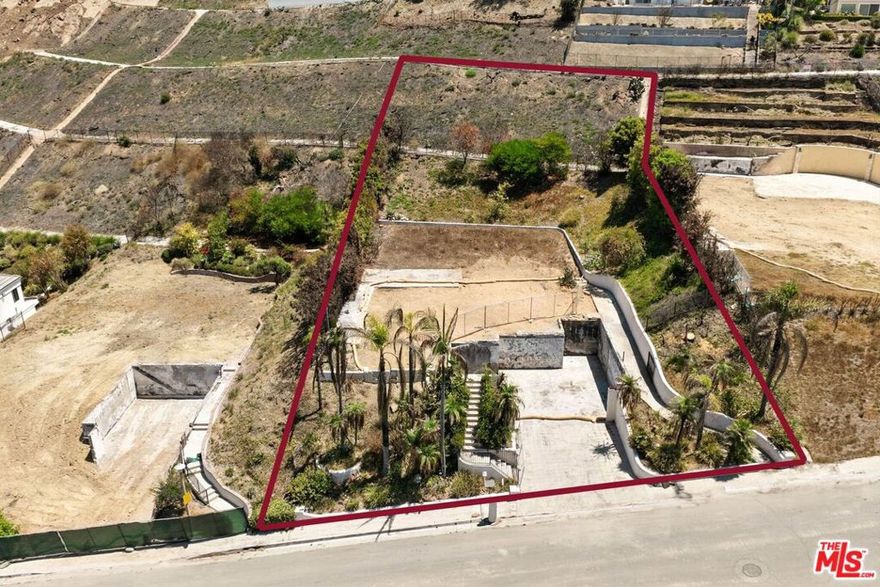 Large, beautiful lot in the Palisades Highlands! This expansive 17,493 sq ft lot offers canyon and mountain views and privacy. The homes to left and right were unseeable from this lot and the homes above the lot are still standing and the beautiful home across the street is still standing. Located on a very quiet street. This is your opportunity to build your dream home in one of LA's most desirable neighborhoods. The lot previously had a 3495  sq ft residence.  Access to the community amenities including a pool and tennis courts. Phase 2 debris removal has been completed. HOA dues are $500 per month for the clubhouse (which is being rebuilt), pool, and tennis courts; an additional $90 per quarter for use of the private park. HOA includes all common area maintenance and 24/7 patrol and vacation watch.