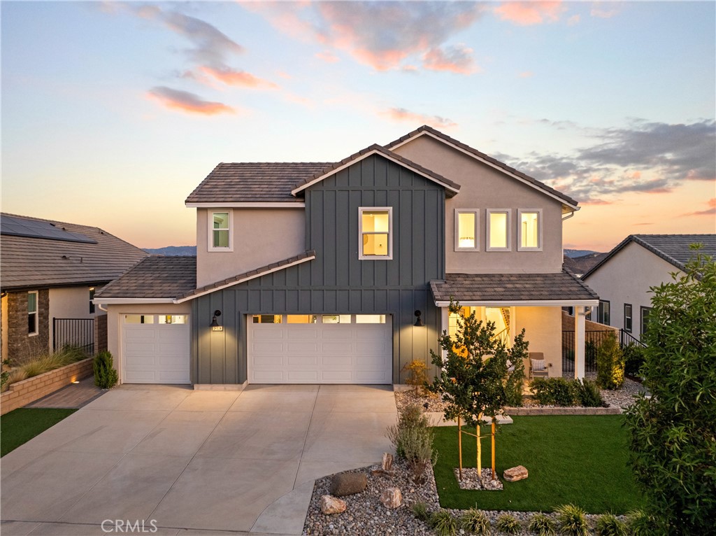 Welcome to Williams Ranch, an exceptional gated community thoughtfully designed with lifestyle and leisure in mind. This beautifully upgraded two-story home is part of the sought-after Meadow Collection and offers nearly 180-degree panoramic VIEWS of rolling hills and twinkling evening lights. The spacious layout features 3 bedrooms, 2.5 bathrooms, a generous multi-purpose loft, and 3 car garage. The open-concept kitchen with beautiful cabinets and a gorgeous center island flows seamlessly into the family room, where triple sliding doors lead to a covered patio, perfect for entertaining. As you venture upstairs, the steel baluster staircase wraps around an elegant custom chandelier. The primary suite features a spa-inspired en suite bathroom with an oversized shower, dual sinks, a spacious walk-in closet, and a multi-slide door leading to a private balcony with stunning views. The custom landscaped front and back yards feature artificial turf, concrete tile, lush lawn, river rock, ambient lighting, a resistance swim pool, and a relaxing jacuzzi, all on an incredible lot ideal for celebrations or quiet evenings at home. Additional highlights include luxury vinyl plank flooring downstairs, an upstairs laundry room, custom lighting fixtures, automatic window shades, ceiling fans, a tankless water heater, and PAID solar. Set within a master-planned community surrounded by the Sierra Pelona Mountains, near shopping, restaurants, and freeways, Williams Ranch offers a unique blend of tranquility and convenience. Planned amenities include a junior Olympic-size pool, outdoor kitchen, scenic hiking trails, citrus orchards, vineyards, a wine pavilion, pocket parks, and a state-of-the-art recreation center. If you're looking for a modern home with space, style, and stunning views in a vibrant community, this is the one. Come experience life at Williams Ranch!