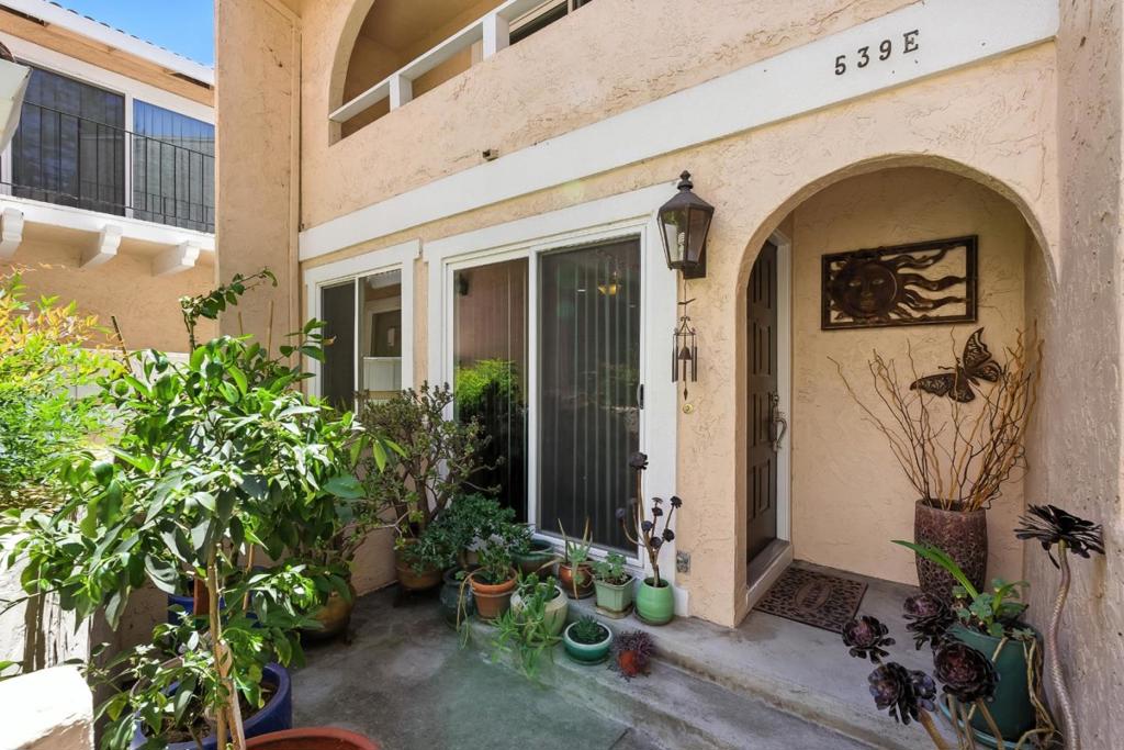 Rare end-unit townhome that lives like a single-family home. Spacious with two oversized bedrooms, each larger than typical single-family rooms. Enter through a private 2-car garage or serene front patio. Enjoy the open layout with stainless steel kitchen appliances and seamless flow to dining and living areas, ideal for daily living or entertaining. Stay comfortable year-round with air conditioning and double-pane windows. The primary suite features a private balcony with peaceful garden views. Ample storage throughout. HOA covers sewer, garbage, and exterior maintenance. Close to shopping, dining, parks, trails, commuter routes, and Silicon Valley employers.