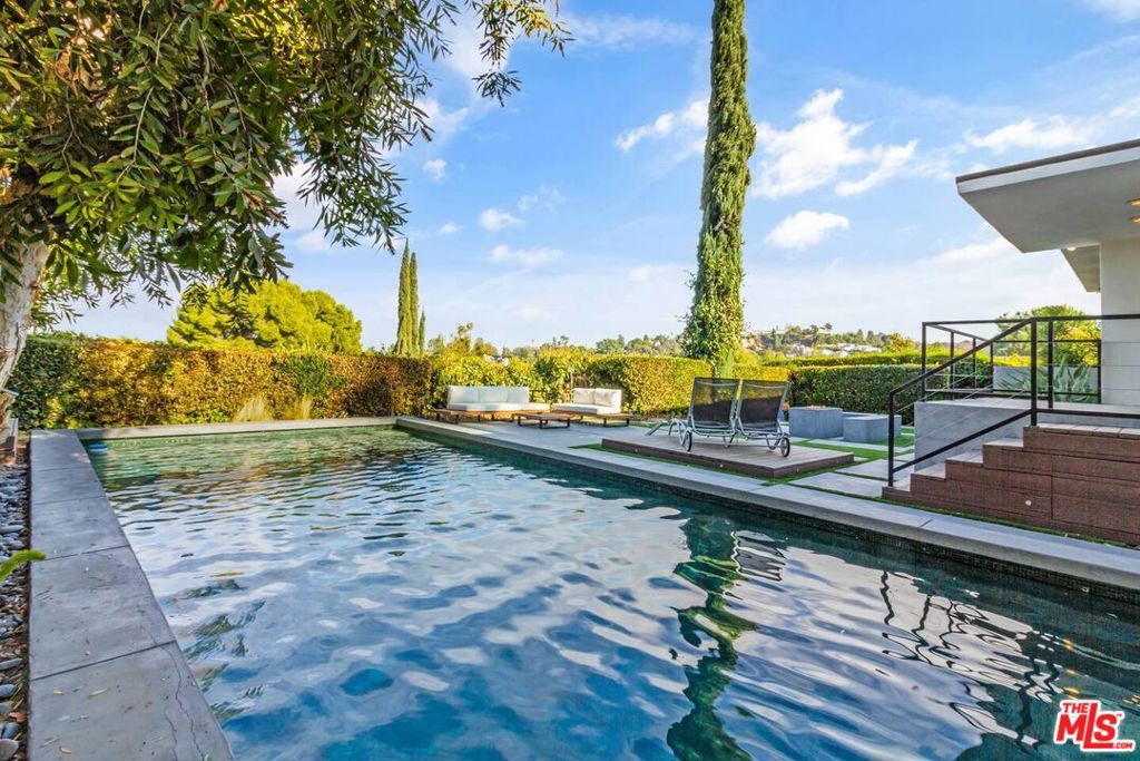 Modern flag lot 4BR, 2.5BA home perfect for relaxation and entertainment! The lovely master suite presents a gorgeous view of the city. The spacious backyard, complete with a pool and patio lounge area, is perfect for enjoying the scenery of the city and mountains. Enjoy a gym room featuring a Peloton, weights, and a pull-out bed for staying active in privacy. With TVs in every room and a state-of-the-art movie theater boasting a DTS Dolby sound system, you'll have endless entertainment options.The home is private yet ideally located near local attractions, making it the ultimate retreat for families, friends, or business trips. 4th BR is an extra space with a pullout bed.