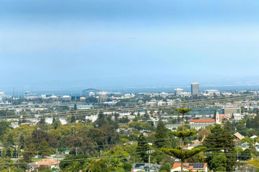 `Sweeping Bay Views on an oversized lot in San Mateo Hills. Unobstructed views of San Francisco, the Bay Bridge, San Mateo Bridge, and Eastern Foothills highlight this 4bed, 3 bath, 2,640 sq ft home on a 15,450 sq ft lot. The main level features a bright living/dining room with faulted ceilings, fireplace and deck. A sun filled, oversized kitchen with stainless appliances, gas cook top and large island are ideal for entertaining. Three bedrooms and a hall bath complete this level and the primary suite has mesmerizing views. The lower level adds a large family room with a second fireplace, bedroom with separate exterior access, office, an additional room ideal as a kitchenette and patio access. Lower level is perfect for an in-law unit. A gardeners delight, mature landscaping, fruit trees and a huge level yard offer an ADU or swimming pool potential. Minutes from Laurelwood Shopping Center, Downtown San Mateo, parks and major freeways - this move-in ready home offers breathtaking vistas and room to grow.