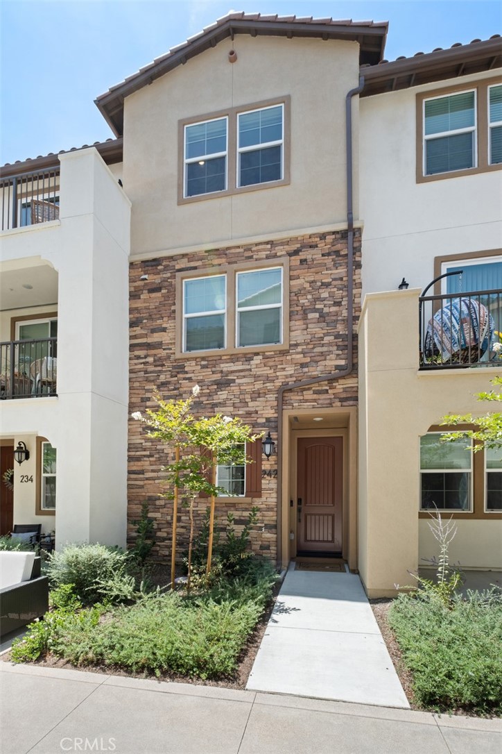 Luxury townhome in the newly constructed community of Saddleback Place! This thoughtfully designed Plan 4 model features over $45K in premium upgrades including flooring, lighting, upgraded appliance package, countertops, ceiling fans, shiplap accent wall, and window coverings, all in a prime location near the pool and BBQ area. Arrive through your 2-car tandem garage with keyless entry and a side jog-out space perfect for a home gym or office. The main level features an airy open-concept great room designed for entertaining and everyday relaxation. Living and dining areas flow outside onto a sunny balcony perfect for a BBQ and seating area. Enjoy casual bites and conversation at the center island, complemented with chic quartz countertops and white Shaker cabinets. Home chefs will love the quality kitchen appliances and bonus storage pantry. Wake up to peekaboo ocean views and breezes from the primary and secondary bedroom. All three bedrooms offer great natural light, and three full bathrooms provide excellent privacy and convenience for family and guests. The primary suite features a larger double-sink vanity as well as professional organizers in the walk-in closet. Additional upgrades include a tankless water heater, mobile garage control, and leased solar with a fixed monthly bill of just $84. The Saddleback Place community offers exceptional amenities with NO MELLO ROOS, including a sparkling pool with cabanas, tot lot playground, walking paths, and BBQ areas. You'll have easy access to parks, trails, restaurants, shopping, and schools, plus exclusive Lake Mission Viejo access for hiking, fishing, boating, concerts in the park and seasonal events. This home delivers the perfect blend of luxury and lifestyle in one of Mission Viejo's most desirable new communities.