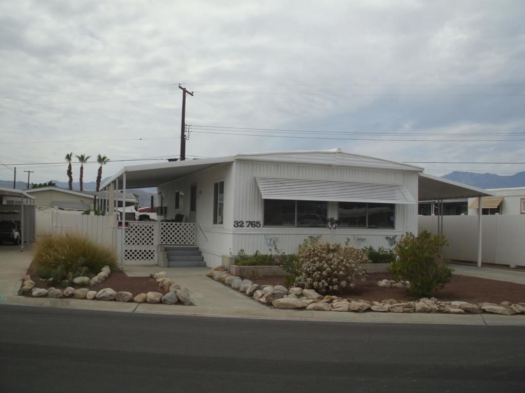 This well-maintained Double wide manufactured home 2-bedroom 1 & bath with large back yard. Close walking distance to the Club house. Offered Furnished. Very bright a clean. Many upgrades through the years. Windows and Bathrooms upgraded. Detached golf cat shed. Golf cart is negotiable. Tri Palm Estates is a 55+ community with many social activities, Low HOA fees allow 2 owners on deed all the golf they can play on our 2 fine Golf courses, Shuffleboard courts, Tennis and pickleball courts, 2 pools, 2 hot tubs, Restaurants and Bar. Close to Costco, Sam's Club, Walmart, Home Depot, Lowe's, And many fine restaurants