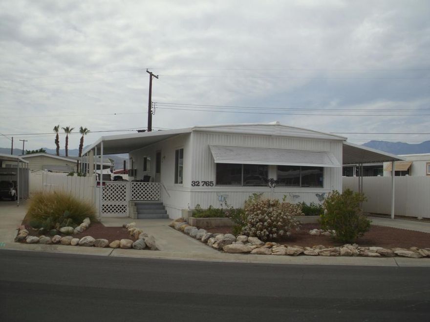 This well-maintained Double wide manufactured home 2-bedroom 1 & bath with large back yard. Close walking distance to the Club house. Offered Furnished. Very bright a clean. Many upgrades through the years. Windows and Bathrooms upgraded. Detached golf cat shed. Golf cart is negotiable. Tri Palm Estates is a 55+ community with many social activities, Low HOA fees allow 2 owners on deed all the golf they can play on our 2 fine Golf courses, Shuffleboard courts, Tennis and pickleball courts, 2 pools, 2 hot tubs, Restaurants and Bar. Close to Costco, Sam's Club, Walmart, Home Depot, Lowe's, And many fine restaurants