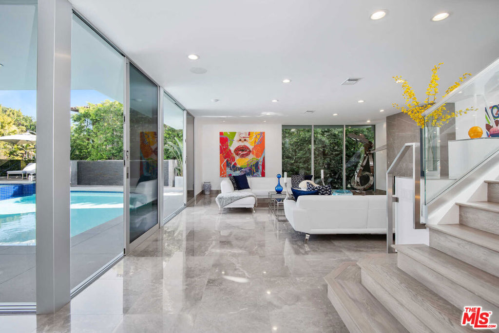 THE SELLER IS OPEN TO LEASING THE PROPERTY FULLY FURNISHED, OFFERING A UNIQUE OPPORTUNITY for a sophisticated lifestyle IN ONE OF THE MOST SOUGHT-AFTER LOCATIONS. IMMEDIATE OCCUPANCY AVAILABLE. Experience the epitome of luxurious living, nestled adjacent to some of the wealthiest individuals in the world amidst a prestigious enclave that includes Beverly Hills and Holmby Hills. This exquisitely designer-furnished contemporary residence is a remarkable architectural triumph that rises gracefully above the city lights, offering breathtaking panoramic views.This opulent masterpiece features expansive living spaces with unparalleled finishes, all thoughtfully designed for seamless entertaining. The open floor plan boasts soaring ceilings and expansive sliding glass walls that integrate indoor and outdoor spaces, leading to resort-style amenities, including a magnificent pool, spa, and multiple entertainer's terraces embellished with cascading waterfalls.A grand great room, anchored by a sophisticated fireplace, transitions effortlessly to a fully equipped bar complete with top-of-the-line temperature-controlled wine storage. This space flows into a stunning dining room and a state-of-the-art chef's kitchen, outfitted with Miele appliances and Poggenpohl cabinetry, perfect for culinary enthusiasts.The lavish primary suite offers a private terrace with captivating views, extensive showroom-quality closets, and exquisite dual bathrooms. Accompanying this are three generously sized VIP guest suites, a cutting-edge media room with sweeping vistas, and a fully equipped gym featuring a dry sauna, all contributing to this extraordinary high-tech smart home retreat. THE SELLER IS OPEN TO LEASING THE PROPERTY FULLY FURNISHED, OFFERING A UNIQUE OPPORTUNITY for a sophisticated lifestyle IN ONE OF THE MOST SOUGHT-AFTER LOCATIONS. IMMEDIATE OCCUPANCY AVAILABLE.