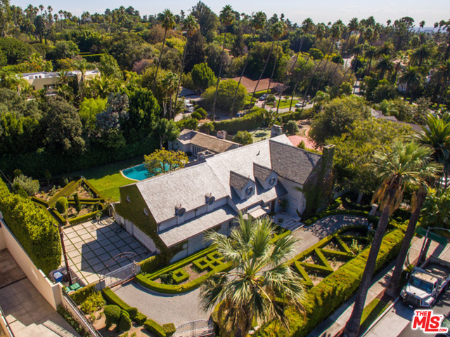 This is it! The perfect flat rectangle lot in the most prestigious spot North of Sunset in Beverly Hills. Poised on over half an acre of flat land exactly two blocks from the Beverly Hills Hotel, this gorgeous traditional estate offers the most beautiful landscaping and large backyard with guest house (approx 970 square feet), pool, and rose garden. The approximately 5,800 square foot gated home offers 5 bedroom, 7 bathrooms and amazing quality. A gracious two-story entry opens to a handsome wood paneled library and expansive formal living room. The large gourmet kitchen features state of the art appliances including a La Cornue stove. The perfectly manicured grounds come complete with topiary, rose and vegetable gardens, and picturesque Beverly Hills palm trees. Perfect for entertaining and relaxing in the sun and escaping to the French countryside while just minutes from busy city life.
