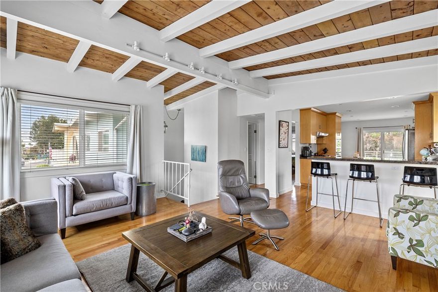 Tucked away on a peaceful two-block street in the coveted Hermosa Hills, this tastefully remodeled 3-bedroom, 2-bathroom home blends coastal charm with modern comfort. Step inside and head upstairs to the open, sun-filled living area, where soaring open-beam wood ceilings and newer vinyl windows create an airy, inviting vibe. The remodeled kitchen is a showstopper—featuring stainless steel appliances, a built-in microwave, a 5-burner stovetop, and lighter wood soft-close cabinetry perfect for both preparing everyday meals and entertaining. Off the kitchen, a sliding glass door leads to a composite deck—perfect for taking in the twinkling city lights or heading straight down to the private backyard for relaxing or recreation. The extra-wide lot provides room for both. The upper level also includes a bedroom and a sleek hall bath with a generous walk-in shower. Downstairs, you’ll find two more bedrooms and a shared bathroom, plus direct access to the serene backyard through sliding glass doors. Whether you step out from the lower level or head down from the deck, the private rear yard is yours to enjoy from both floors of the home. Practical perks? Fresh interior paint, recessed lighting, wood floors, updated windows and a two-car garage with direct entry. All this just blocks from Hermosa Beach’s vibrant dining and shopping scene, an easy bike ride to the sand, and right around the corner from the newly upgraded Hermosa View School and Sea View Park and playground.

This is more than a house—it’s your next chapter in one of the South Bay’s most sought-after neighborhoods.