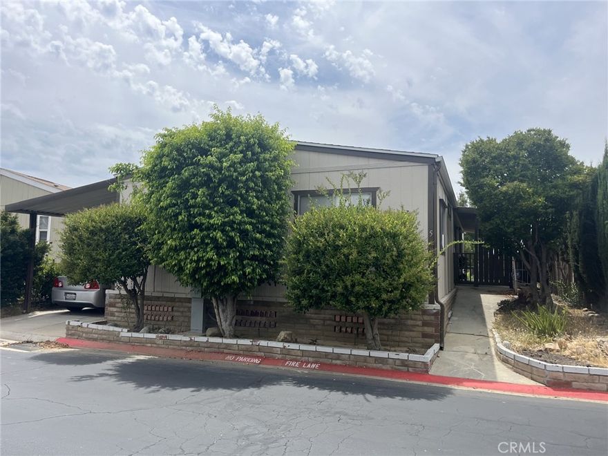 Welcome to this beautiful home located in Woolsey Canyon with amazing views!  This home features a view of the local mountains and is nestled in a quiet gated community.  This home offers 1,440 square feet of large open living space and 2 bedrooms and 2 bathrooms.  Walking up to the front of the home, you have a private gate and courtyard to the back of the home.  The main living area has large windows for enjoyment of the scenic views.  The living room features a fireplace and is open to the dining room, which has a built in hutch.  The kitchen has ample cabinet and countertop space along with updated appliances and a breakfast bar.  The laundry room is expansive with tons of storage, counter tops, a full size washer and dryer and leads to the carport.  The formal dining room is located by the kitchen and has a slider to the front courtyard.  The primary bedroom features 2 closets, one with mirrored sliding doors, natural light and an ensuite.  The ensuite has a large soaker tub and a walk in shower, double vanity and laminate flooring.  The other bedroom is also very spacious and has a large closet.  The main bathroom has a shower/tub combination, storage, a large vanity and laminate flooring.



This home is located in the very desirable Canoga Park area and is the lowest priced in the park.



Schedule your showing today!