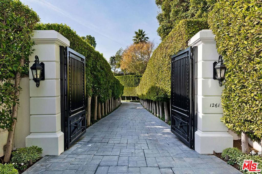 If you've seen this home before, you won't recognize it now! In the most coveted section of lower BHPO sits this remarkably secluded and timelessly elegant Contemporary Villa view estate. Approached via a gated and hedged "billionaires' row" private drive coupled with an enormous motorcourt, this rare and sophisticated gem will please the entertainer in all. Panoramic views of the city and ocean are exhibited from many sunlit rooms along with super high ceilings, gorgeous wide-plank wood floors, and walls of glass. The living room, study/library, owner's retreat, and dining room all open to the grounds which include a 90ft wide covered terrace, patios, stunning elongated lap pool, spa, and views. Grand main floor owner's retreat with foyer, sitting area, fireplace, views, dual crisp white baths, and room-size walk-ins. 3 generous guest bedroom suites are located in two separate upstairs wings. Chef's center-isle kitchen with top newer stainless appliances and a big atrium-style breakfast area. Featuring a pedigree from world-renowned designer, Kalef Alaton, this estate will be certain to enchant and impress its fortunate new owner.
