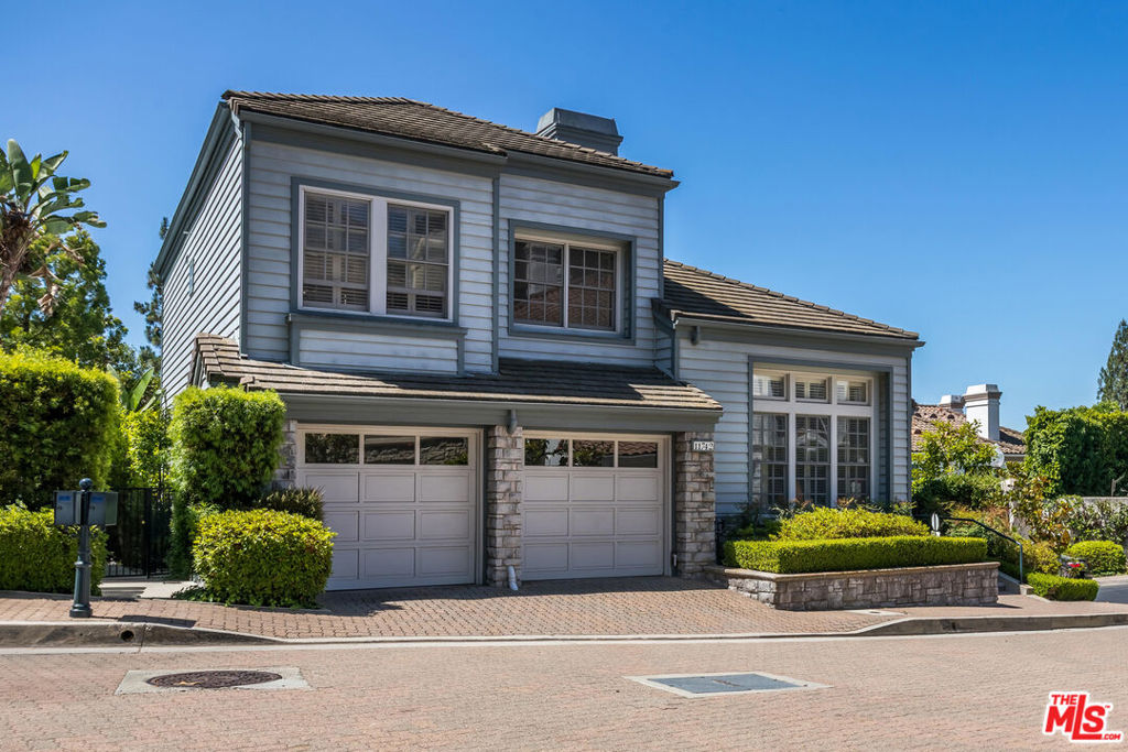 Located on a quiet corner lot in the guard-gated community of Bel Air Crest, this lovely Cape Cod-style residence offers a thoughtful blend of elegance and comfort. The bright main level features distressed hickory floors, high ceilings and oversized windows flooding the home with light and air. A marble fireplace anchors the spacious living room, and the step-down dining room with built-ins is bathed in sunlight. The large chef's kitchen includes granite counters, abundant storage, stainless double ovens, Viking cooktop, Sub-Zero refrigerator, and a beautiful beamed ceiling. The kitchen opens to a comfortable family room with custom built-in bookcases and French doors leading to a private backyard with a lovely stone fountain. A custom bar, powder room, laundry room, and direct entry 2-car garage complete the main level. The high ceilings continue upstairs, which offers a huge primary suite with an oversized bathroom, walk in closet, and a charming balcony with treetop views. Two additional bedrooms and another full bath complete the second level. Bel Air Crest's amenities are unparalleled, including a newly renovated clubhouse, resort-style swimming pool and spa, fitness center, basketball courts, tennis and pickleball courts, a putting green, playground, dog park, and serene hiking trails. Get away from it all in your own gated retreat that offers the epitome of Southern California living. Bel Air Crest residents also have access to award-winning Roscomare Road Elementary School.