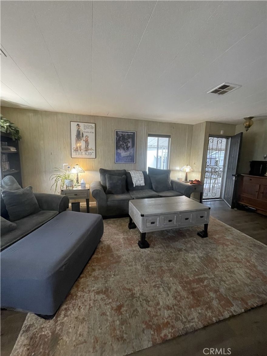 Spacious Manufactured Home with Large Lot in Gated Community

Located in the desirable Rancho La Paz Mobile Home Park, this 2-bedroom, 2-bathroom home offers a wonderful opportunity to own in a gated, all-age community. The park spans both Anaheim and Fullerton, and this home is ideally situated on the Fullerton side.

Set on a very large lot, the property offers plenty of space and potential for future improvements. The home features a spacious living room with open dining area, a large kitchen, and covered parking for two cars. Outdoors, enjoy a private patio, two storage sheds, an outdoor freezer, a large lemon tree, and plenty of room to garden or expand. The lot may allow for adding extra rooms or even a closed-in garage.

Home Features:

Bright, open-concept layout filled with natural light

Upgraded waterproof laminate flooring & sub-flooring (professionally replaced 2 years ago)

Entire home re-piped with PEX plumbing (1 year ago)

Custom window blinds with insulating shades in the living room & kitchen for energy efficiency

Brand new water heater (installed less than a year ago)

Foundation equipped with earthquake braced piers for stability

Refrigerator, stove, washer & dryer included

Indoor laundry for added convenience

With a little TLC, this home can truly shine and reflect your style.

Community & Location Perks:

Gated all-age park with pool, hot tub, and community clubhouse with stage & game tables

Pet-friendly community—welcoming for families and pets

Conveniently located near Downtown Fullerton, Disneyland, Honda Center & Angel Stadium

Close to restaurants, shopping, seasonal festivities, and entertainment

Easy access to major freeways for commuting

Why rent when you can own? With a large lot, valuable upgrades already completed, and room to personalize, this home is a fantastic alternative to condos or apartments at an affordable price.

Schedule your showing today!