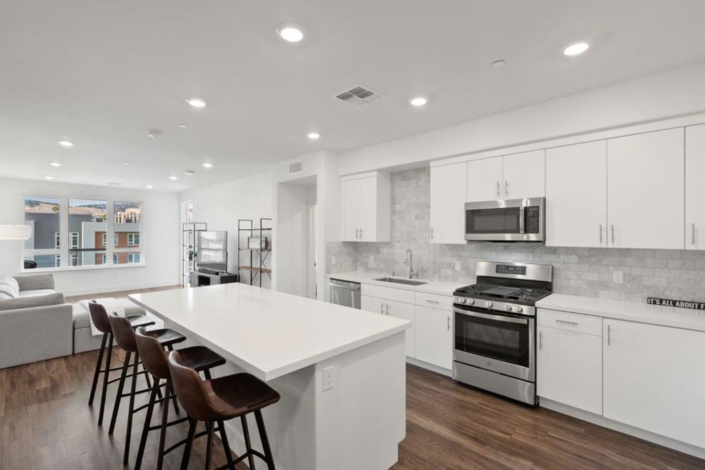 PENTHOUSE CONDO WITH SPECTACULAR VIEWS, HUGE BALCONY & 2 ASSIGNED PARKING SPOTS IN SECURE GARAGE!!! Built in 2019, Still Feels Brand New! NO STAIRS Getting To Or Inside Unit!! 2 SUITES PLUS DEN Which Is Recorded As A 3rd Bedroom - Use For Home Office, Nursery, etc. Open Floor Plan, Lots Of Windows Overlooking Hills & Courtyard & Tons Of Light. Stunning Kitchen w/ Quartz Counters, Huge Island w/ Breakfast Bar, Soft-Close Cabinets & SS Appliances Incl. GAS STOVE! Primary Suite w/ Large Walk-In Closets & Large Bathroom w / Walk-In Shower & Dual Vanity. Balcony w/ Solar Lights, Patio Tiles & Furnishings - Can Be Included! SMART FEATURES: Smart Doorbell, Smart Thermostat, Smart Lutron Lights - Control Everything w/Alexa Voice Control On Echo Show - All Included! Work From Home: CAT6 Wiring, AT&T Fiber Ready. Secure Building Access & 2 Assigned Parking Spots In Parking Garage w/ EV Charging Station. Community Has 12k Luxury Club w/ Giant Pool, Spa, Gym, Weight Room, Event Center (Can Rent For Private Events), Lounges, Fireplaces, Yoga Room & More! Community BBQ/Picnic Areas, Playground & Community Gardens! Next To Several Parks, Outdoor Rec, Shopping & Dining! Quick Access To 85/101 or VTA Light Rail. About 5 Miles To Silver Creek & 11 Miles From Downtown SJ, Campbell & Willow Glen.