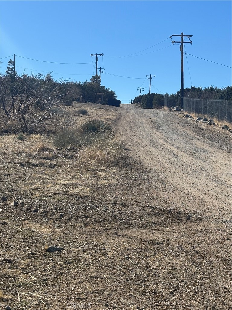 CORNER PROPERTY! Lot surrounded by Houses. Exceptional piece of vacant land in Juniper Hills! A serene getaway to relax in the afternoons and gaze at the stars at night. Absolutely stunning LOT has immense potential.This vacant land boasts a breathtaking 360-degree panorama of natural beauty that will leave you in awe.
