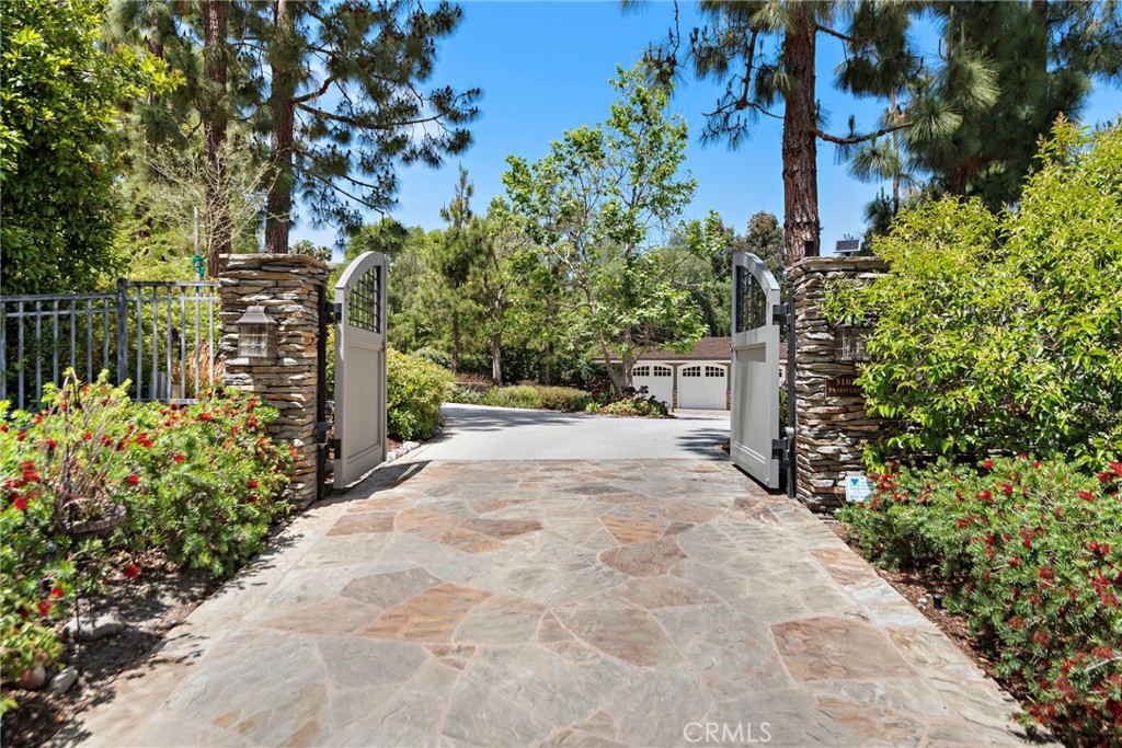SECRET GARDEN MEETS EVERYDAY LUXURY IN SAN JUAN CAPISTRANO
This "ALL SEASON'S" Retreat is set on over an acre of lush, park-like grounds, this enchanting Craftsman-style estate blends Cape Cod elegance with the relaxed sophistication of San Juan Capistrano. Behind private gates, discover a magical world of luxury, whimsy, and thoughtful design—where every detail is crafted to inspire comfort and delight. The main residence welcomes you with warm oak flooring, an open-concept layout, and picturesque views from every room. Five bedrooms and three fireplaces create a sense of cozy grandeur, while the chef’s kitchen takes center stage with a Wolf range, four ovens, and a gleaming stainless steel island—designed for both function and flair. Upstairs, the expansive primary suite spans the entire floor, offering a private office and four balconies to soak in the serene beauty of the grounds. Outdoors, the lifestyle amenities are unmatched: a saltwater pool, 6-hole putting green, built-in trampoline, and half basketball court. Two raised garden beds and a variety of fruit trees add a touch of rustic practicality, while a 900 sq ft guesthouse provides a luxurious haven for visitors. Whether entertaining under the stars or enjoying a quiet morning on one of the master balconies or in one of the garden areas, this rare estate offers an unmatched blend of fantasy and function—where elevated living meets everyday ease.
WELCOME TO SAN JUANDERFUL!!