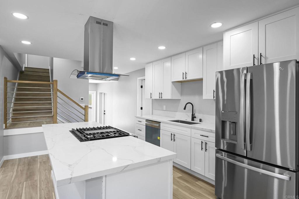 Charming, turn key, newly remodeled two-story home that perfectly blends modern upgrades with timeless charm. Step into an open-concept layout featuring sleek new laminate flooring, fresh paint throughout, and a stunning chef’s kitchen complete with stainless steel GE appliances, quartz countertops, white shaker cabinets, and a center island perfect for entertaining. Kitchen seamlessly flows into family room with wood burning fireplace. The spacious main-floor primary suite includes a beautifully updated en-suite bathroom, and a walk in closet. The second bedroom is just off the family room and guest bathroom while the third bedroom is upstairs offers a private guest bedroom — ideal for an office, guests or family. Downstairs, you'll find a large finished basement that can easily transform into a home gym, home theater, game room, dedicated office space or extra storage for all your belongings. Enjoy energy efficiency with solar panels and a Tesla battery system. Additional highlights include an attached garage and a fully fenced, private yard offering peace and privacy in the heart of the city. Don’t miss this move-in ready gem in one of San Diego’s most convenient locations!
