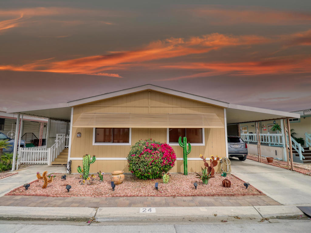RANCHO CASITAS 55+ Gated Community HOA only $160/MO. You Own the Land!!This home shows pride of ownership from the minute you step inside you are greeted with a spacious living area, vaulted ceilings, and six windows for lots of light. Beautiful Pergo Flooring throughout with an abundance of storage! Starting with the Built In Bookshelves flanking each side of the window bringing the morning light from the East. A Quartz Bar top connects the living area to the kitchen adding to the spacious feel of the room. Highlighting the meticulous attention to detail the homeowners took in the many upgrades during the remodel, including the addition of an island with a skylight overhead, creating more light, counter space and storage. The Island is perfect to sit and have your morning coffee or your nightcap from the amazing Wet Bar adjacent to the kitchen. Next to the bar is a cozy Dining area. Glass shelving at the bar with mirror back wall adds to the brightness of this grand space. Down the hall you'll find a cozy Guest Bedroom with a large reach in closet and plush carpeting. The hall bath has been upgraded to Roman Travertine shower walls and backsplash with a Solid Surface one piece vanity. Continuing down the hall past the Furnace closet and a large hall closet, we come to the Primary Bedroom. Spacious and cozy. A custom Barn Door leads in to the Primary Bath, where you'll find a spacious towel closet. Double Quartz vanity, 2 Roman travertine vessel sinks each with its own tall decorative chrome faucet. Safety was on the home owners mind when the shower was remodeled to a low step in with thick safety glass enclosure. Travertine walls, built in shelves and decorative sliced river rock floor. From the primary bedroom you'll find a cute permitted addition for a nice office or craft/sewing room with a roomy walk in closet. Mobile Homes don't usually have a back door this one does!! It leads to the spacious front porch. There you will find the back steps that lead you to the expansive no maintenance back yard! A dog area for your furry friend. Two large storage sheds. Shaded and private, an entertainers haven!This is a MUST SEE!!