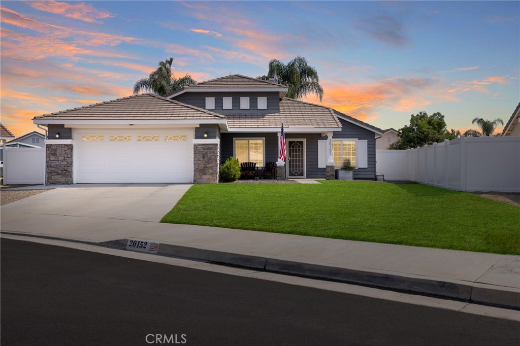 Welcome to this turnkey, beautifully upgraded 3 bedroom, 2 bathroom single-story home with OWNED solar, offering just under 1,200 sq ft of living space on an expansive 7,400 sq ft lot. Nestled on a quiet cul-de-sac with LOW taxes and no HOA, this charming residence features stand out curb appeal with lush grass, drought-tolerant landscaping and a welcoming front patio boasting gorgeous mountain views. As you step inside you'll discover thoughtful upgrades throughout, including LVP flooring, custom paint, blinds throughout and a cozy gas fireplace with a wood mantle that anchors the open-concept living and dining area. The kitchen is both functional and inviting, complete with white tile countertops, white cabinetry, 5 burner gas stovetop, stainless steel appliances, tile flooring and generous storage. As you continue past the main living area, a T-shaped hallway guides you to the home’s private living quarters. To the left, you’ll find access to the attached two-car garage, which includes laundry hookups, built-in storage cabinets, and a 220V outlet for EV charging. This side of the hallway also leads to one of the secondary bedrooms, which features plush new carpet, a ceiling fan, and gorgeous mountain views, along with stylish accent wall paneling. Adjacent to this bedroom is the secondary bathroom featuring a white single-sink vanity, custom lighting, black slate tile flooring, and a shower/tub combo. Continuing straight through the hallway, you’ll find the second secondary bedroom, offering plush new carpet, a ceiling fan, and peaceful views of the backyard with an abundance of natural light. Just beyond is the entrance to the primary suite featuring LVP flooring, ceiling fan, and tons of natural light, as well as private sliding glass door access to the backyard. A custom sliding barn door opens to the beautifully upgraded en-suite bathroom featuring dual vanities, white cabinetry with black hardware, shiplap paneling, custom lighting, a private toilet area, custom tile flooring, and a walk-in shower finished with white subway tile and matte black finishes. Step outside to your private backyard oasis! The pool-sized lot features a patio cover with ceiling fans, low-maintenance turf, vinyl fencing, and a custom play structure with a sandbox, offering the perfect outdoor space. This charming residence is also within walking distance to William Collier elementary school and just minutes from Highway 74 and the 15 freeway—making it ideal for commuters!