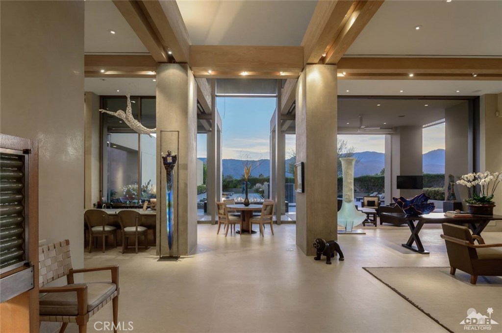 This incredible custom estate was designed by Jim Olson of Seattle. This home was built with no expense spared, as evident in the detail and design. Designed with huge soaring walls of glass, water cascading down walls and electric sliders opening to the pool and rear yard with unbelievable, unobstructed mountain views. Incredible cabinetry in exotic woods, poured concrete pillars, stone clad walls, magnificent public areas, and halls to house the most valuable art work. The main home is 3 bedrooms, one of which is a staff quarters. The master suite has dual baths, a gym, sauna and a small office, with the main office just off the entry hall. The entry door was created by an artist and pivots to open. The bar is exquisite and is itself a piece of art. The guest house is just to the side of the raised swimming pool with its infinity sides and water cascading down a wall at the far end. The guest house has 2 ensuite bedrooms which are separated by a living room with entry