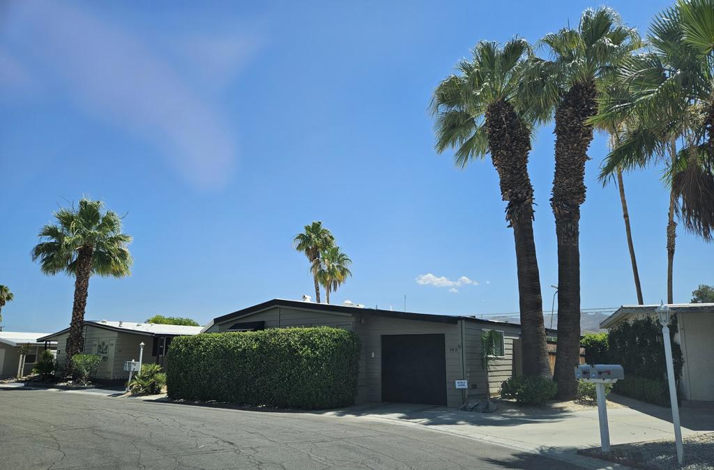 Welcome to 163 Vista De Oeste a rare find in Palm Springs View Estates where comfort, views, and value align. This well-maintained, fully furnished manufactured home is the only property in the community with a private garage, offering unmatched convenience. Enjoy sweeping golf course and mountain views from your covered back and side patios, or take a dip in your private above-ground pool just steps from the community pool. Inside, you'll find 1,440 sq ft of thoughtfully updated living space, including two spacious bedrooms with walk-in closets, newer windows, an informal dining area, and a gas fireplace for cozy evenings. The home has been remodeled and is move-in readya'ideal as a year-round residence or seasonal getaway. And if you enjoy the outdoors, you'll love that this home is located just moments from the Palm Springs bike path, perfect for morning rides or sunset strolls.