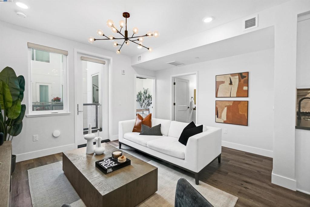 Rare Top-Floor Penthouse Residence! First time on the market since new, this 2-story condo spans the 4th & 5th floors with 3 bedrooms, 3 full bathrooms, and over 1,500 sf of modern luxury in Fremont’s coveted Irvington District. Light-filled and spacious, it features soaring ceilings and an upgraded kitchen with stainless appliances—including a gas range (a rare find!), hood, dishwasher, microwave, Samsung Bespoke glass-door refrigerator—plus white shaker cabinetry, quartz countertops, matte black hardware, and imported designer tile backsplash. Upstairs, two private primary suites include en-suite baths—one with a walk-in closet—while bathrooms showcase stylish finishes. Elegant upgrades include engineered LVP wood flooring throughout and large format tile flooring in the bathrooms. Secure building with 2 elevators, plus 2 deeded garage parking spaces—one with a private EV charger (1 of only 9 in the building!). Community amenities include an event center, fitness facility, BBQ/picnic area, dog run & wash room, bike storage, and playground. Near BART and Hwys 680/880, this penthouse blends high design, convenience, and rare privacy in a sought-after Fremont address.
